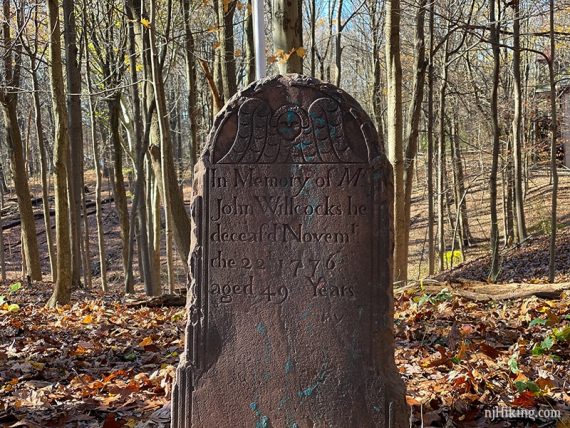 Stone grave marker for John Willcocks, died 1176 at age 49.