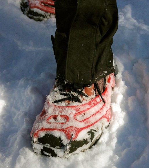 Front of MICROspikes on a hiking boot in snow.