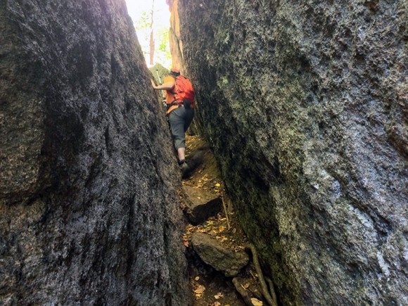 Hiker navigating the Lemon Squeezer along the Appalachian Trail.