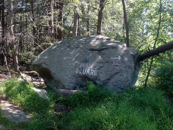 Large boulder with "Times Square" painted in white.