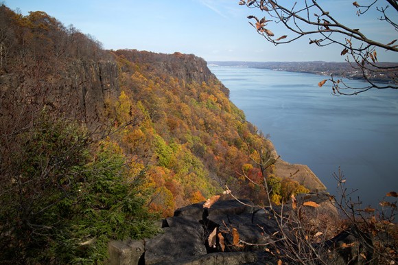 Steep cliff covered with fall foliage.