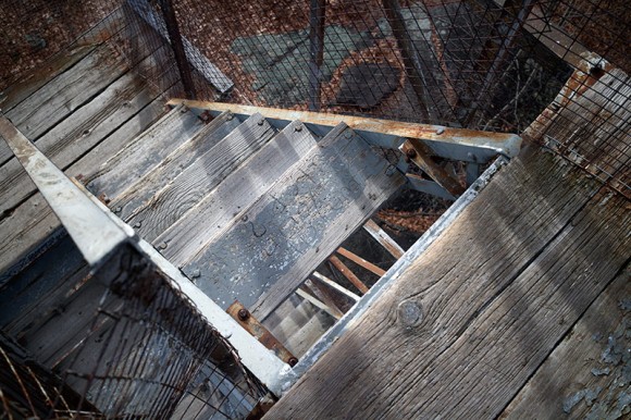 Looking down wooden steps in a fire tower.