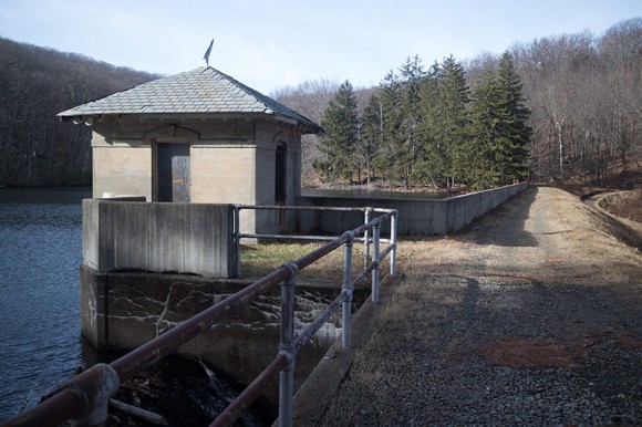 Utility building at the edge of a dam.