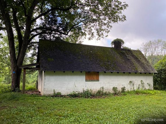 White farm building with dark roof.