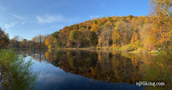 Orange and yellow foliage reflected in Ghost Lake.