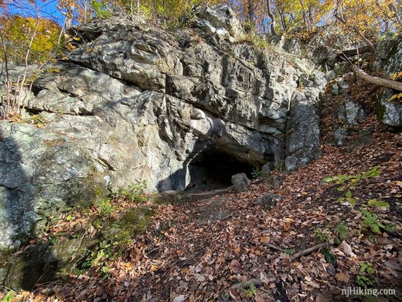 Small cave in a large rock face.