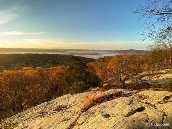 Rocky outcrop overlooking low hills.