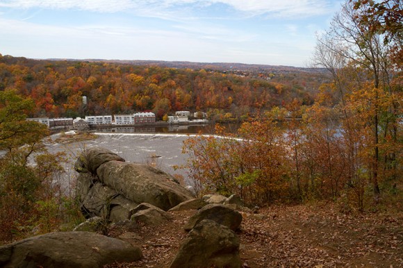 Rocky outcrop overlooking buildings on the other side of the Delaware River.