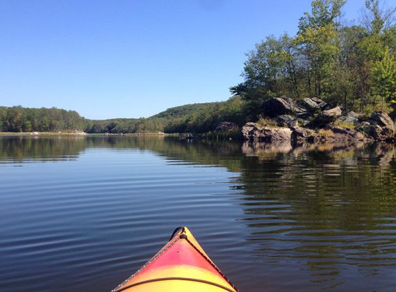 Large rocks on the shore of a reservoir.