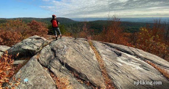 Hiker on from Osio Rock looking over hills.