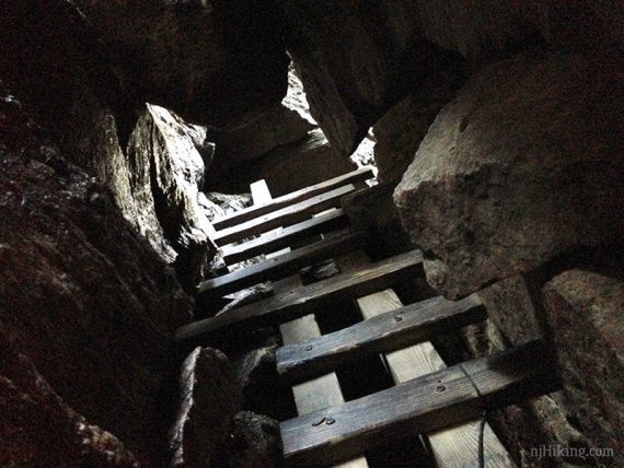 Ladder squeezed into a rock crevice.