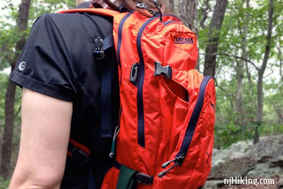 Orange backpack on a hiker.