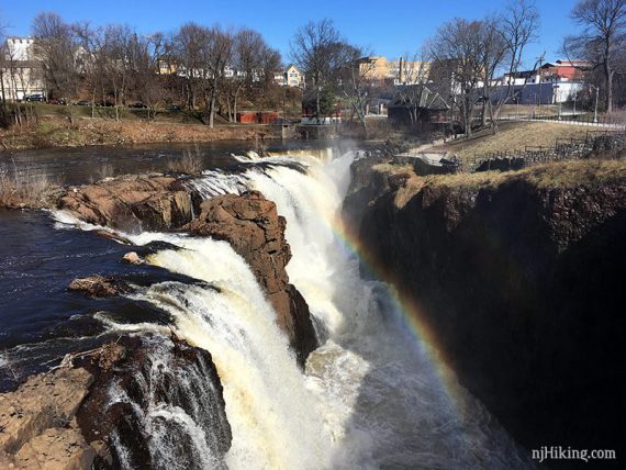 Paterson Great Falls tumbling over rocks with a rainbow visible.