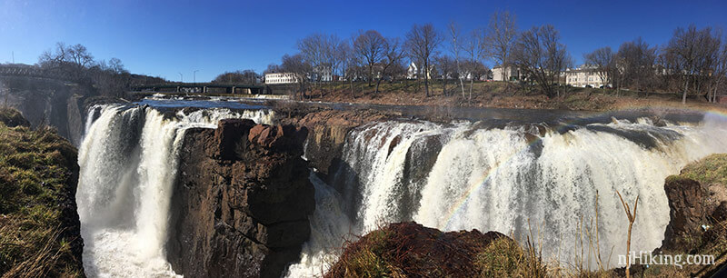 Panoramic view of a massive waterfall tumbling over steep rocks.