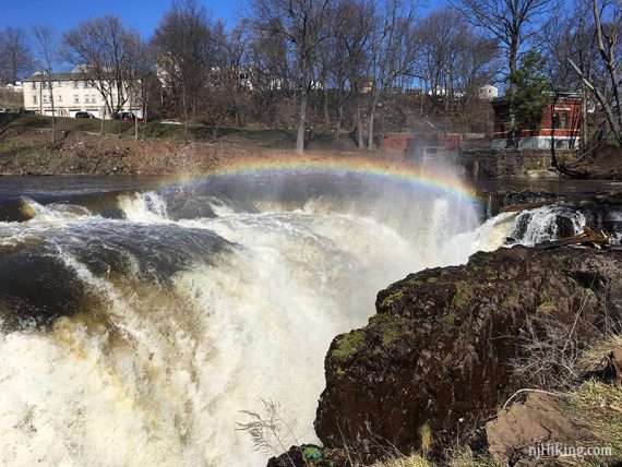 A rainbow arching over a waterfall.