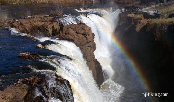 A rainbow above water crashing over Paterson Great Falls.