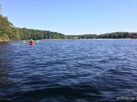 Kayaker on choppy blue water.