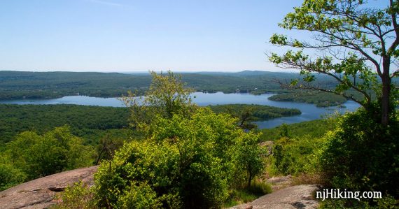 Curved Wanaque reservoir seen from a rocky outcrop.
