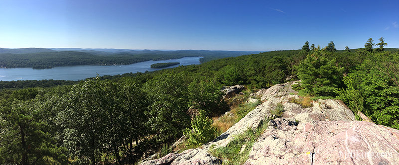 Wide view of Greenwood lake with a rock slab in the foreground.
