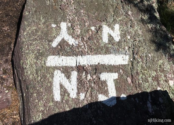 N.Y and N.J painted on a rock slab at the state line.