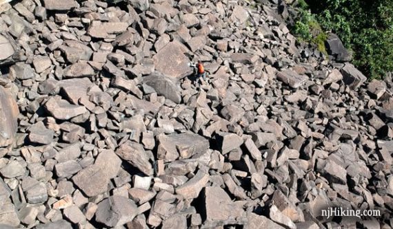 Hiker navigating a boulder rock field called the Giant Stairs.