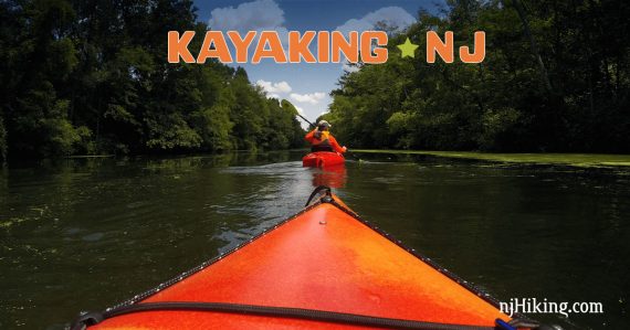 Kayaker seen from the bow of a kayak with the words "kayaking NJ" overhead.