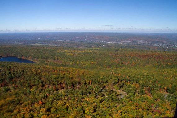 Looking down on foliage covered hills of NJ and PA.