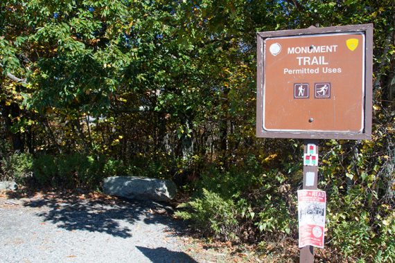 Monument Trail sign at the end of the parking lot.