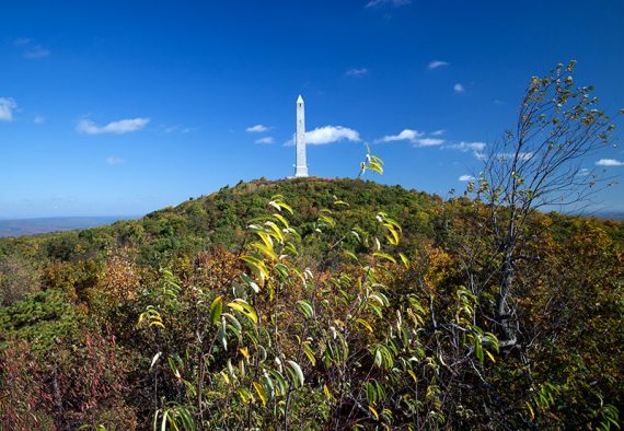 High Point monument on top of a hill seen from the viewing platform along the Appalachian Trail.