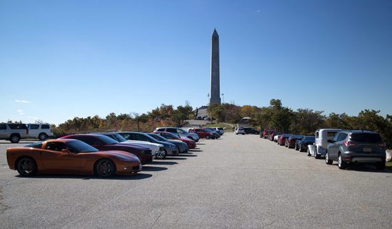 High Point monument at the end of a parking lot filled with cars.