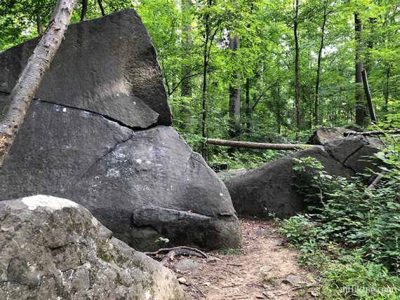 Large angled boulders along a trail