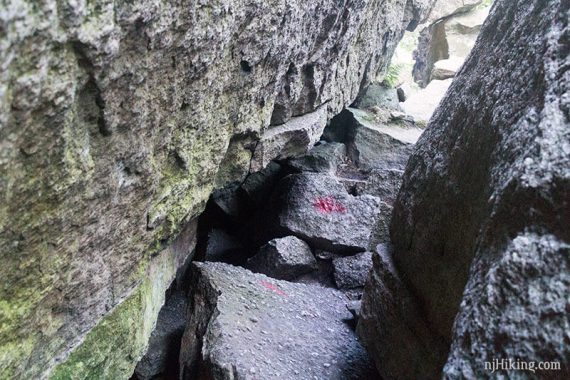 Red mark painted on rocks to show the path through.