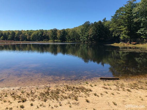 Stony Lake with green trees around it and a blue sky above