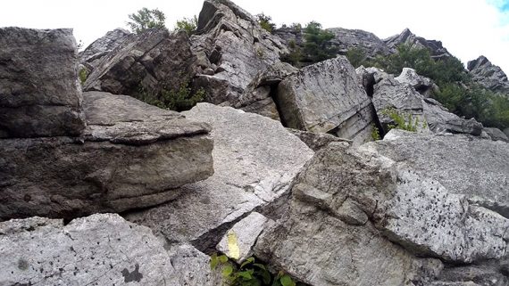 Trail marker showing the path through rocks.