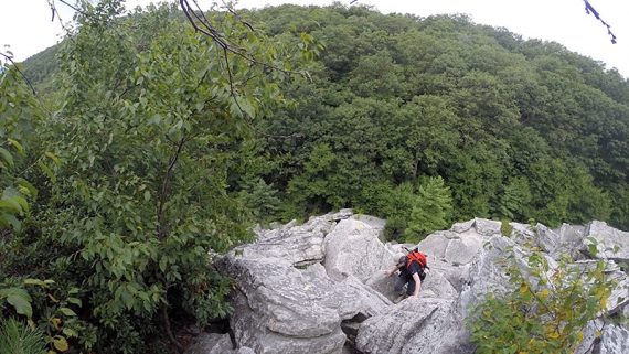 Looking down at a hiker coming up a rock scramble.