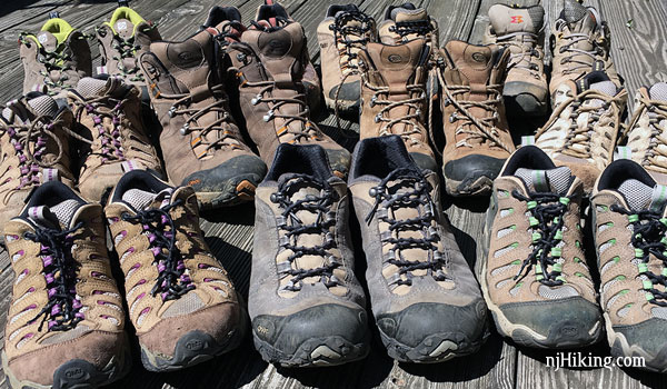 Rows of worn hiking boots.