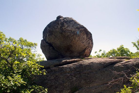 Glacial erratic with a blue trail marker painted on it.