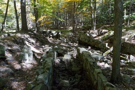 Stone embankments along a trail.