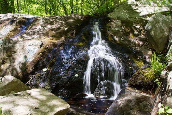 Water cascading over a rock at Otter Hole.