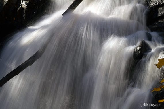 Close up of heavy water flowing over rocks.