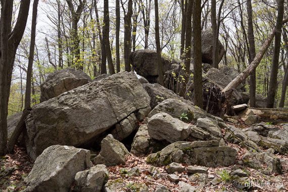 Large pile of boulders on a trail.