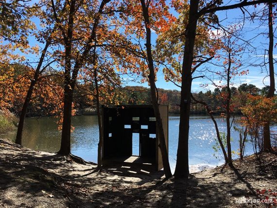 Wildlife blind at the edge of a pond.