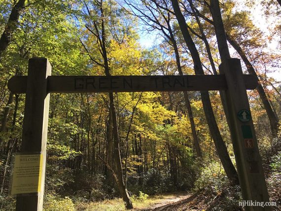 Wooden arch with the words Green Trail carved in it.