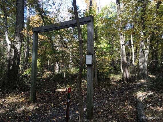 Wooden arch over a trail.