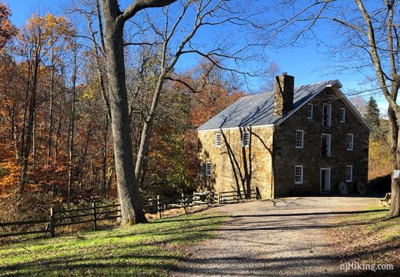 Path and fence next to stone mill building.