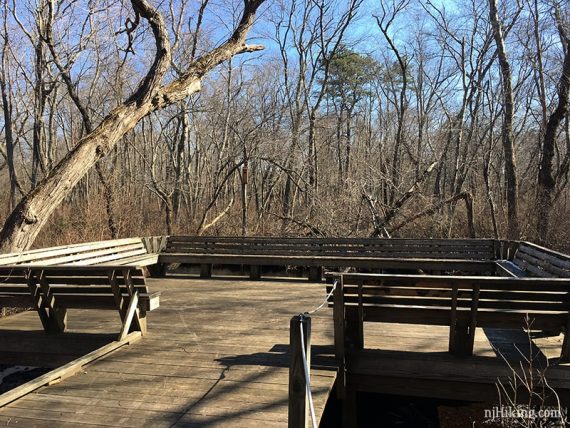 Wooden platform with benches on all sides