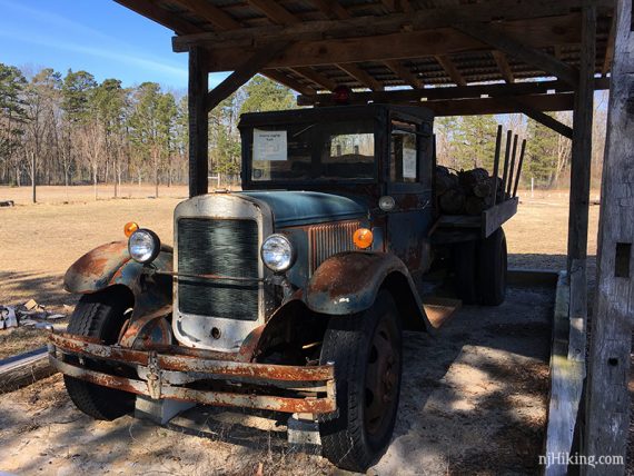 Antique logging truck under a wooden roof