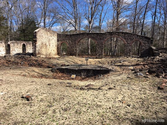 Remains of a stone building with large arches.