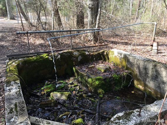 Artesian Well pipe over a cement foundation.