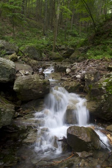 Waterfall tumbling over rocks in a stream.